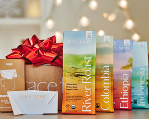 Grace Farms coffee boxes with a decorative bow and gift box in the background