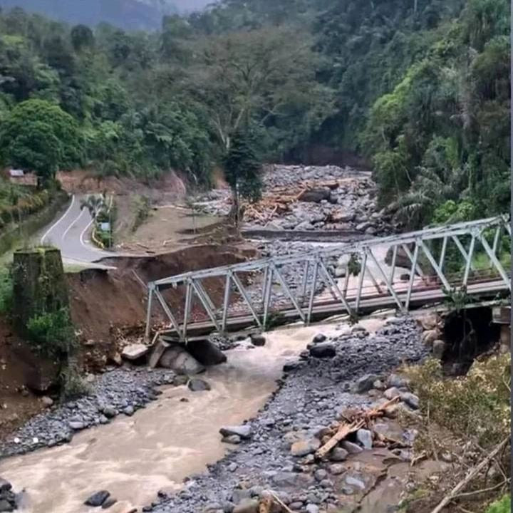 Small bridge over a rocky stream with lush greenery on either side, labeled 'Jembatan enang enang'.