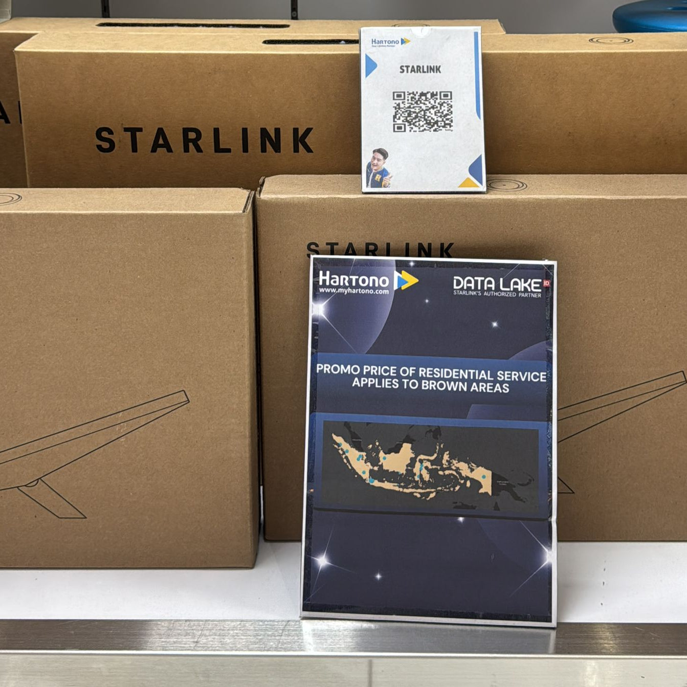 Starlink boxes with promotional materials on a metallic surface