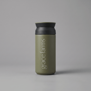 KINTO travel tumbler in khaki, featuring the vertical white text 'grace farms' on the front, set against a solid gray background.