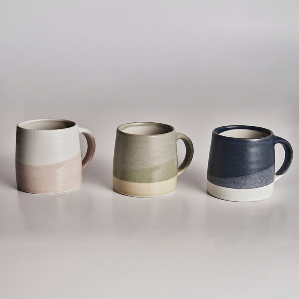 Three KINTOceramic mugs with gradient colors on a plain background